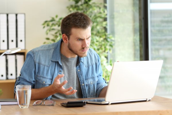 man angry laptop glass of water registry cleaners